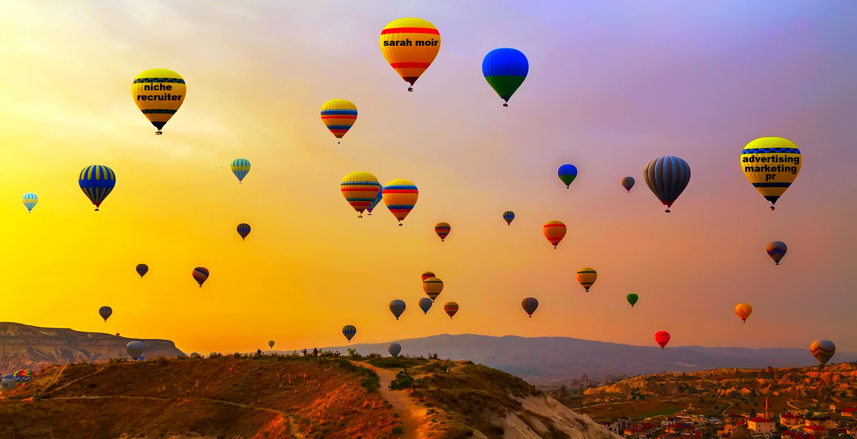 Hot air balloons landing in a mountain Cappadocia Goreme National Park Turkey.